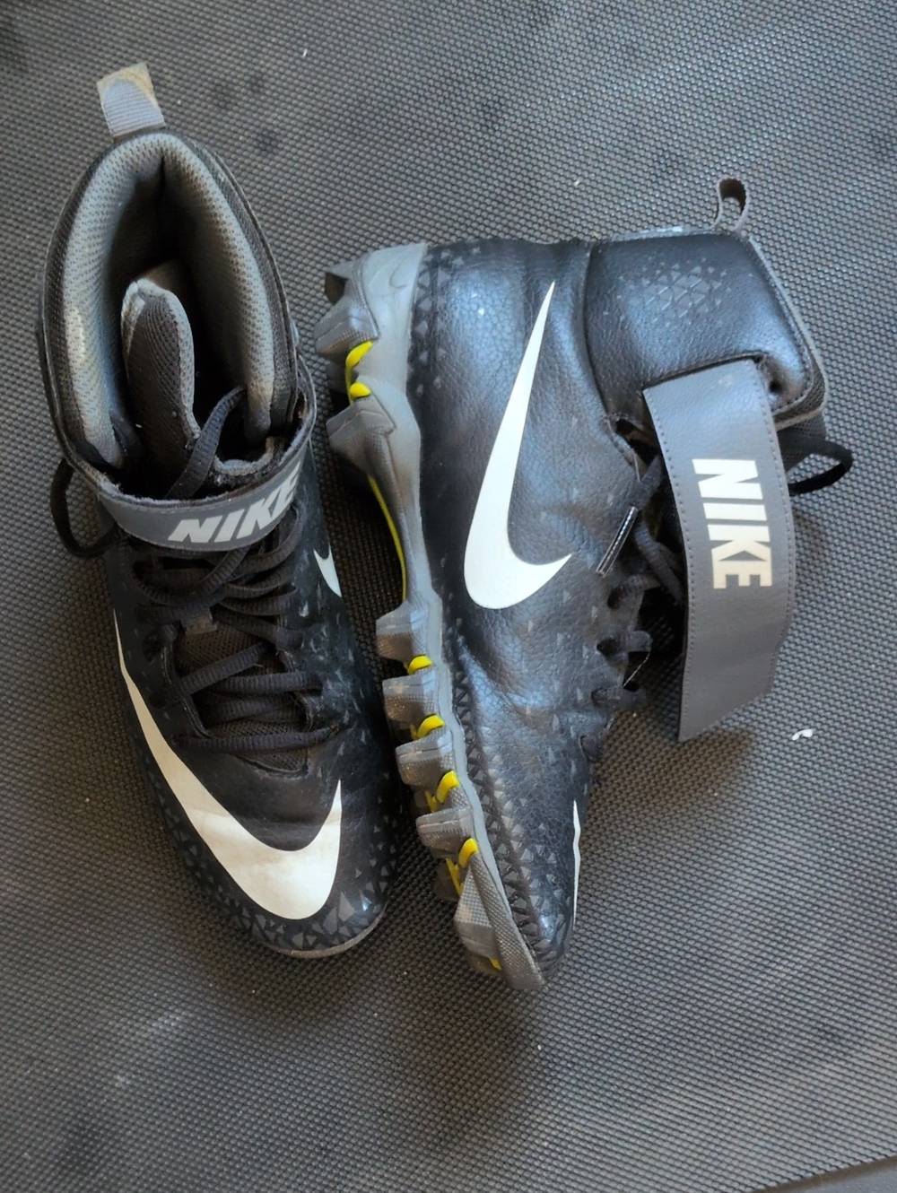 Youth 6 Nike Black and White Football Cleats with Yellow Stud Accents